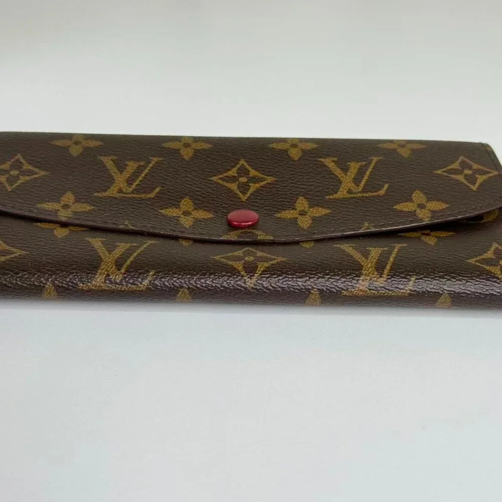Louis Vuitton Monogram Canvas Wallet with Classic Design and Red Pin Detail